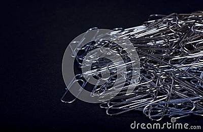 Heap of metal note paper clips on dark background, High details with high contrast Stock Photo