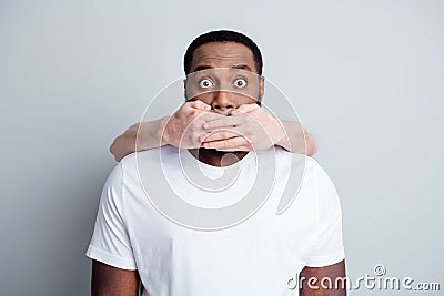 Photo of helpless scared african guy can`t stand unfairly society shut up black citizens white skin arm close his mouth Stock Photo