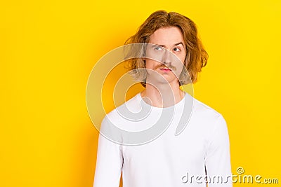 Photo of hesitant young man looking empty space brainstorming find solution isolated on yellow color background Stock Photo