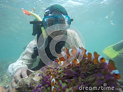 photo of a human being diving and there are sea animals and coral reefs Editorial Stock Photo