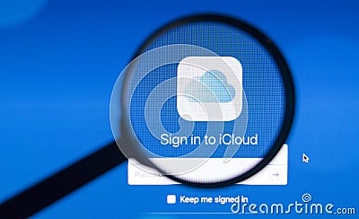 Photo of icloud homepage on a iMac monitor screen through a magnifying glass. Editorial Stock Photo