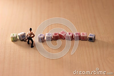 Photo Illustration for change impossible thing into possible one, worker moving I and M letter cube Stock Photo