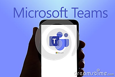 In this photo illustration the logo of the remote team work app Microsoft Teams is seen on the screen of mobile phone and of a lap Cartoon Illustration