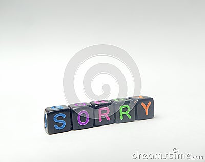 Photo Illustration, Word Sorry from black plastic alphabet cube beads Stock Photo