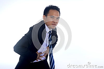 Photo image of a handsome asian businessman suffering from abdominal pain Stock Photo