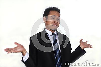 Photo image of a handsome attractive young Asian businessman with i don`t know gesture Stock Photo