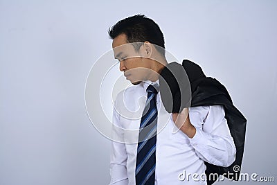 Photo image of young asian businessman holding his suit jacket on his shoulder isolated on white Stock Photo