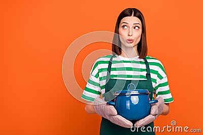 Photo of impressed brunette young lady cook look promo wear striped t-shirt apron isolated on orange color background Stock Photo