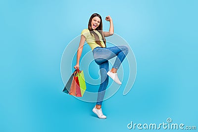 Photo of influencer lady hold store bags celebrate goal attainment wear green top blue color background Stock Photo