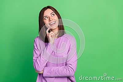 Photo of inspired excited lady look empty space thinking thoughts isolated on green color background Stock Photo