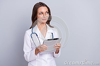 Photo of lady cardiologist hold modern technology device empty space ads vaccine entry isolated grey color background Stock Photo