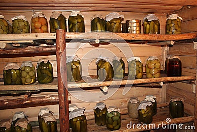 Banks with pickles cucumbers, tomatoes, cabbage in storage Stock Photo