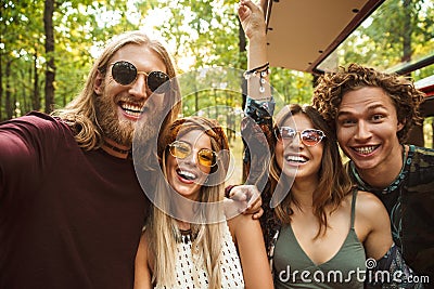 Photo of laughing hippie people men and women taking selfie in f Stock Photo