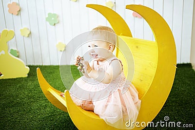 Little girl in yellow dress with decoration in her hair at the m Stock Photo