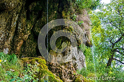 Photo of little waterfall flowing in cave Stock Photo