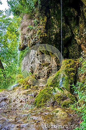 Photo of little waterfall flowing in cave Stock Photo