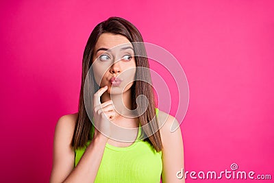 Photo of lovely funny girl finger face lips look side empty space wear green singlet isolated bright pink color Stock Photo