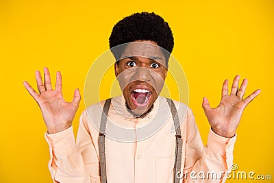 Photo of mad outraged furious guy scream open mouth wear suspenders shirt isolated yellow color background Stock Photo