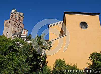 Photo made in Padua in Veneto (Italy) to the tower of the Observatory or the devil and aad a yellow building Stock Photo