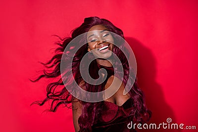Photo of magnificent happy afro american young lady fly hair blow wind glamour isolated on red color background Stock Photo