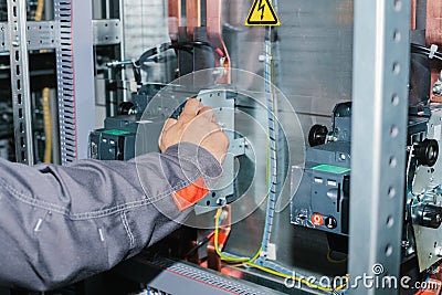 Electrician specialist checking low-voltage cabinet equipment Stock Photo
