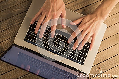 Man hands on laptop keyboard. Top view Stock Photo