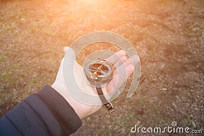 Photo of man`s hand with vintage compass Stock Photo