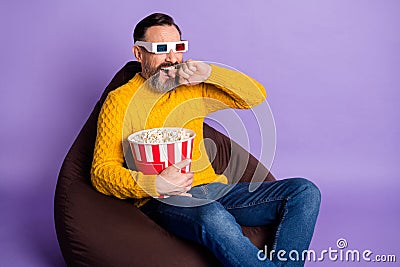 Photo of man sit beanbag bucket popcorn bite finger wear 3d glasses yellow sweater isolated violet background Stock Photo