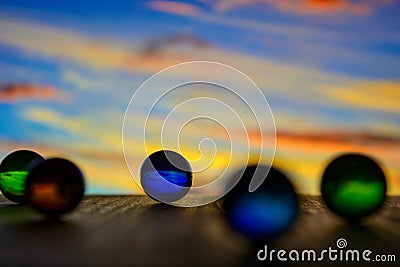 Photo of many glass balls on wooden board on blurred background Stock Photo