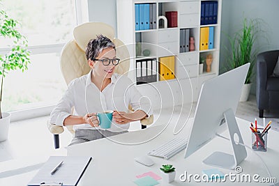 Photo mature age boss business worker woman gray hair hold her cup fresh coffee watch monitor desktop news isolated on Stock Photo
