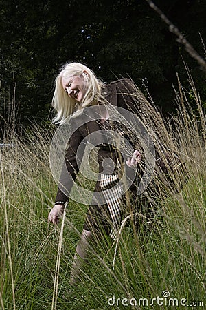 Photo of mature woman walking meadow Stock Photo