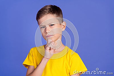 Photo of minded smart clever nice boy wear trendy yellow clothes arm touch face hmm on purple color background Stock Photo