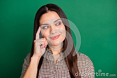 Photo of minded smart lady look empty space finger temple wear plaid shirt isolated green color background Stock Photo