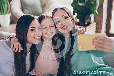 Photo of mommy with sibilings shoot make picture record video cellphone blogging vlogging embrace indoors Stock Photo