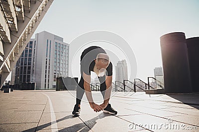 Photo of motivated confident sporty active man stretch hands body exercise cardio warm up urban town outdoors Stock Photo