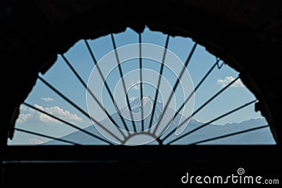 Photo mountains through a semicircular window Stock Photo