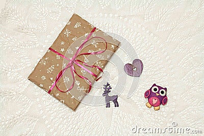 Photo of a New Year`s gift in craft packaging with a felt toy owl Stock Photo