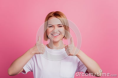 Photo of nice charming blonde lady raise thumb up agree concept wear white t-shirt isolated on pink background Stock Photo