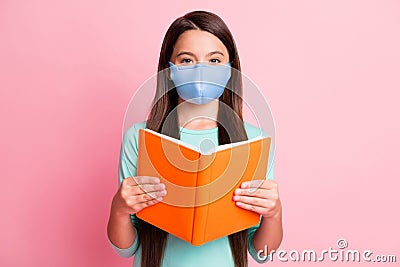 Photo of nice charming long-haired girl reading book wear respiratory teal shirt isolated pink pastel color background Stock Photo