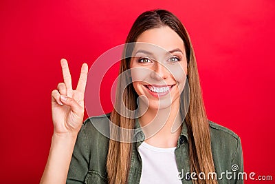 Photo of nice cheerful enjoying overjoyed woman giving you v-sign while isolated with red background Stock Photo