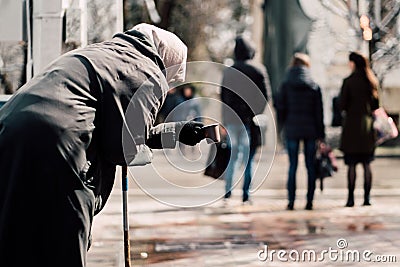 Photo of old hungry homeless female beggar beg and asks for alms on street Stock Photo