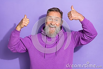 Photo of old pensioner aged bearded grandfather showing thumbs up like feedback crazy recommend isolated on purple color Stock Photo