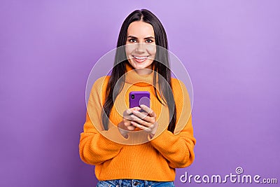 Photo of optimist good mood pretty woman brunette hair wear stylish orange sweater hold phone enjoy apple gadgets Stock Photo