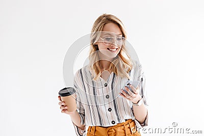 Photo of optimistic attractive woman wearing glasses using cellphone and holding paper cup Stock Photo