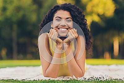 Photo of optimistic brunette hairdo lady lie down rest wear yellow dress outside in park Stock Photo