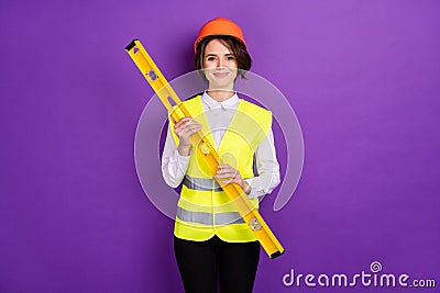 Photo of optimistic nice brunette hair lady hold tool wear builder uniform isolated on purple color background Stock Photo