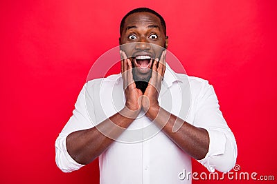 Photo of overjoyed dark skin macho guy wear white shirt isolated bright red background Stock Photo