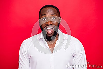 Photo of overjoyed dark skin macho guy wear white shirt isolated bright red background Stock Photo