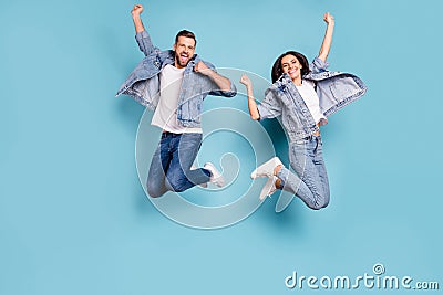 Photo of overjoyed joyful cute nice couple of spouses jumping flying in air happily while with blue background Stock Photo