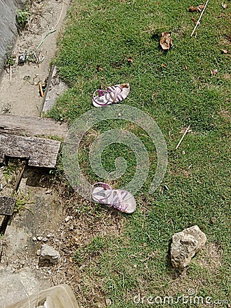 This is a photo of a pair of abandoned sandals Stock Photo